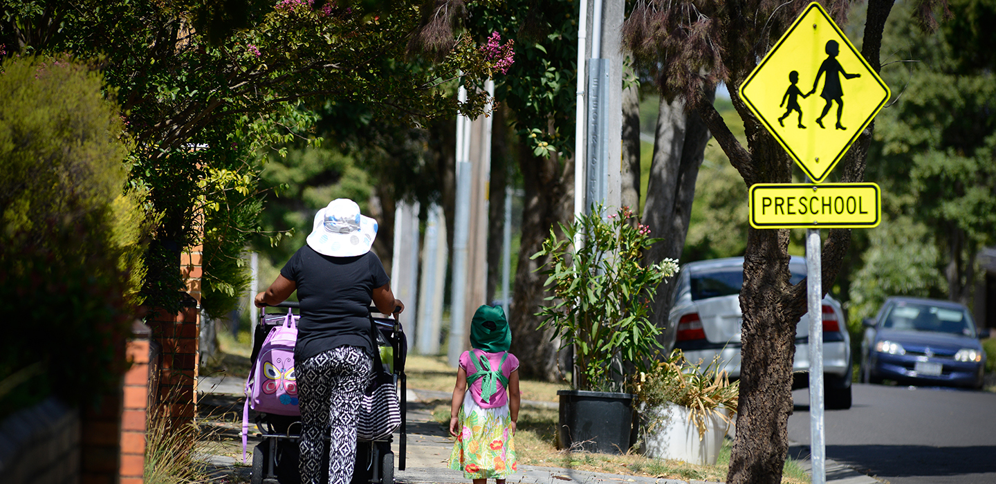 Children walking on a pathway outside a school